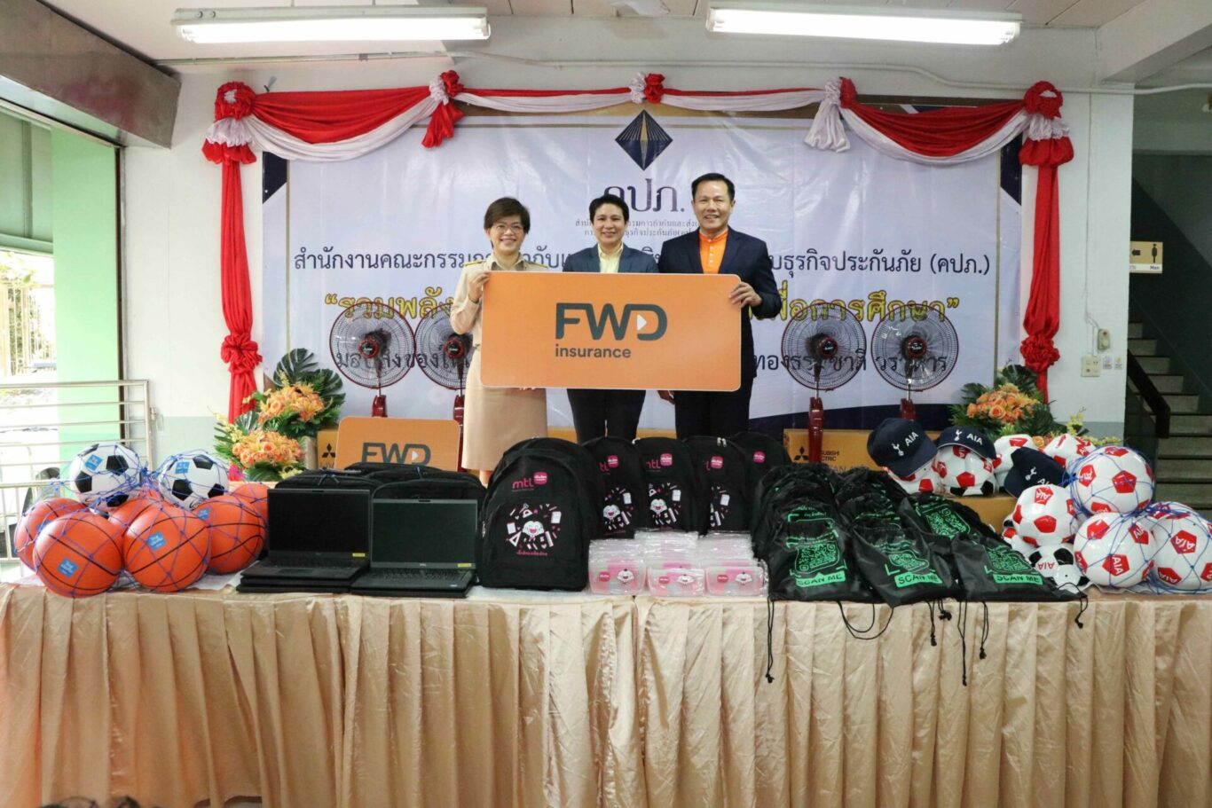 A group of people holding a sign
Description automatically generated