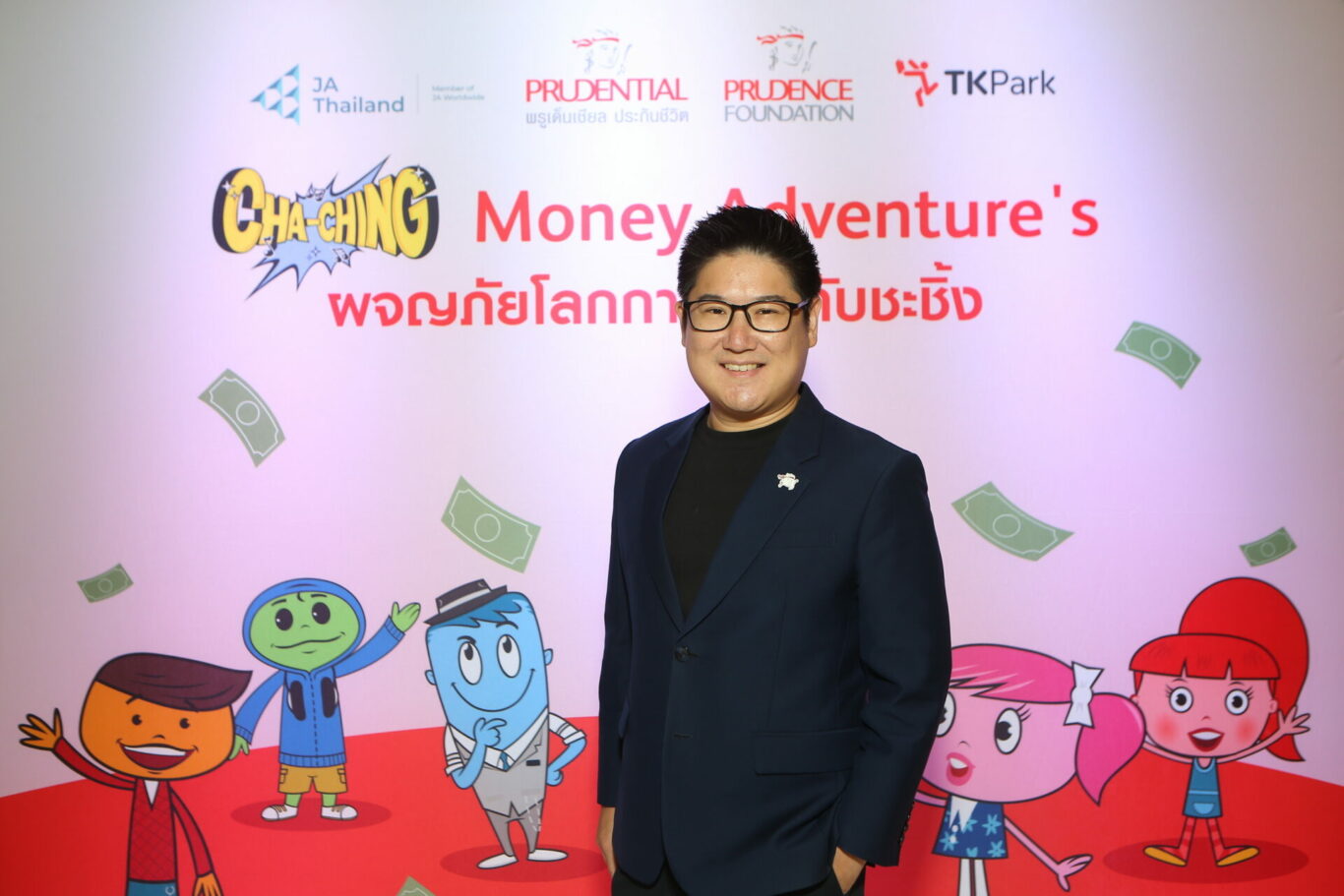 A person standing in front of a wall with cartoon characters

Description automatically generated