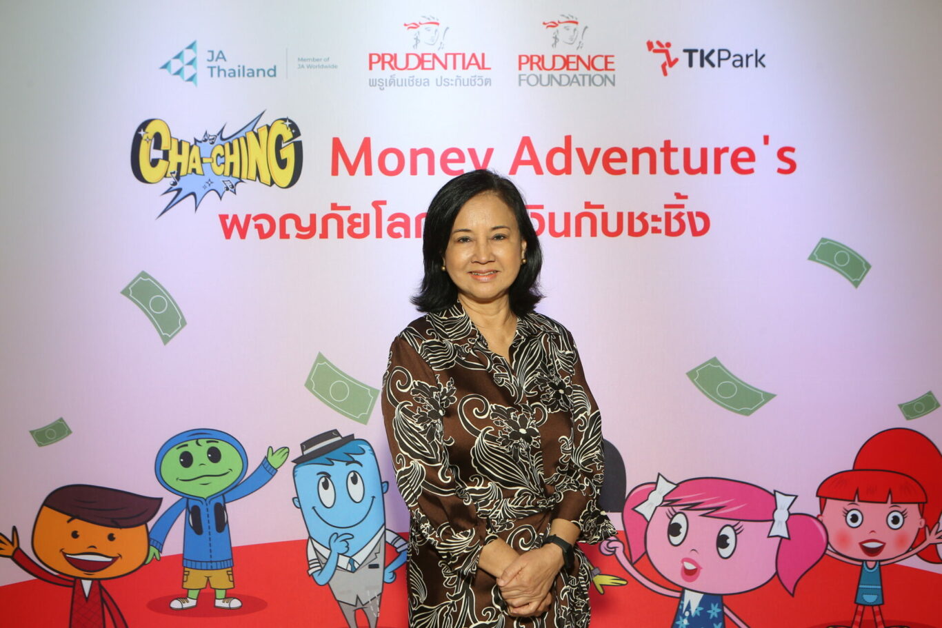 A person standing in front of a sign

Description automatically generated