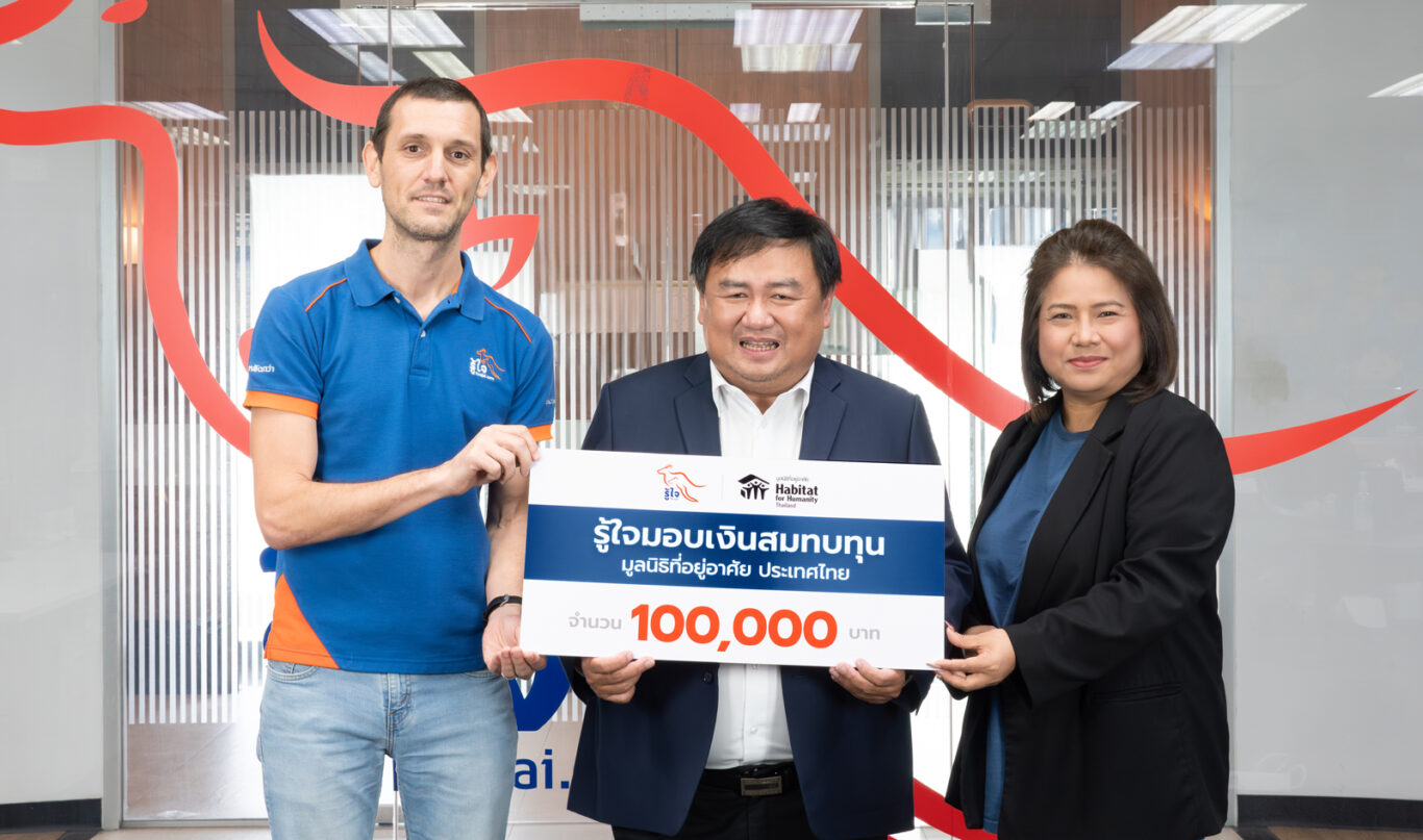 A group of people holding a check

Description automatically generated